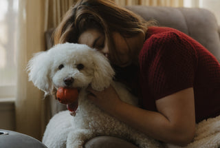 Woman sitting next to her dog during calm moment at home
